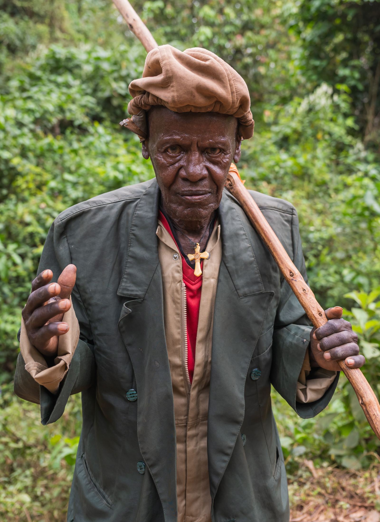 Elder with walking stick in the forest